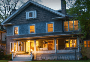 Historic home B&B at dusk with lights on