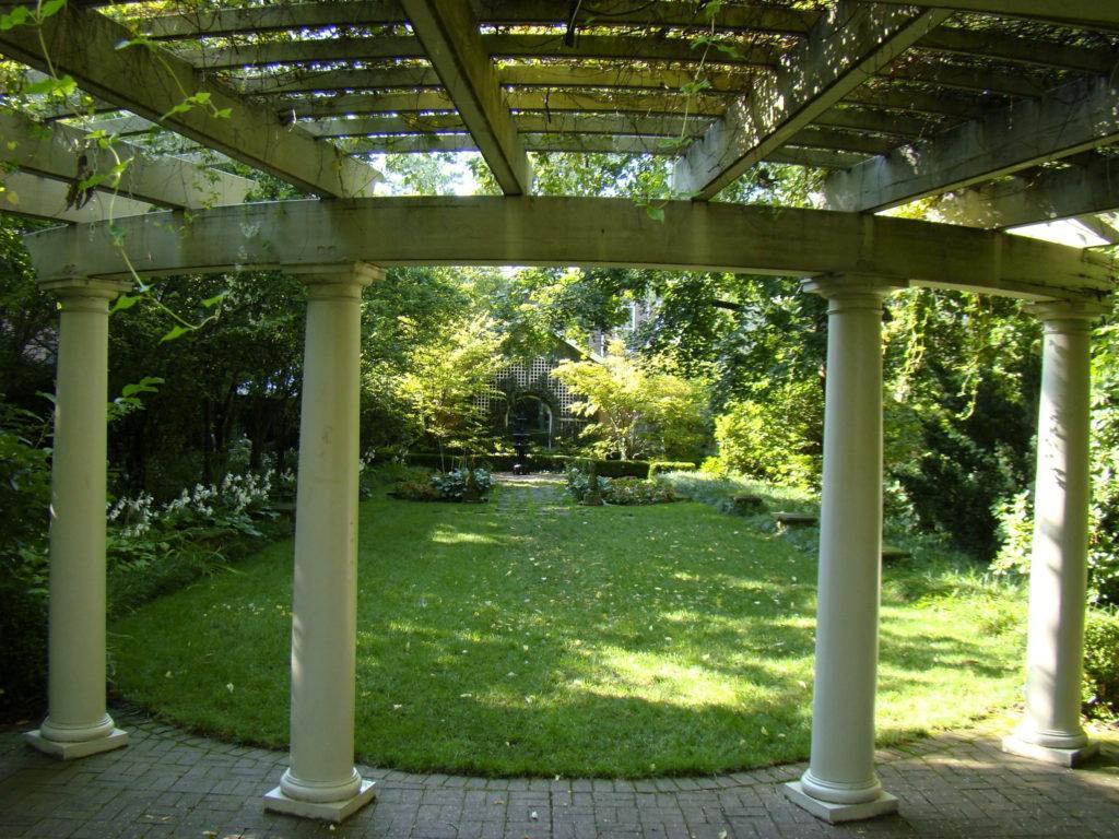 Trellis or pergola with columns looking out of garden at Kelton House